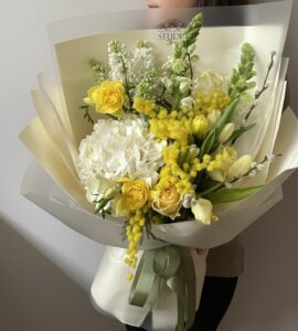 Bouquet of flowers with hydrangea and mimosa 'Sunny March'