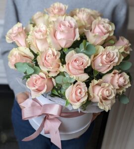 Bouquet of twenty-one roses in a box with eucalyptus