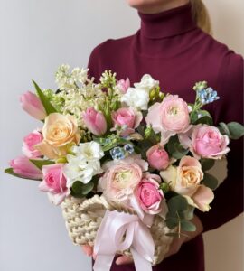 Basket of flowers with lilacs and roses
