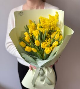 Bouquet of seventeen yellow tulips with momosa