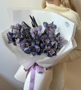 Bouquet of thirteen purple tulips with skimmia