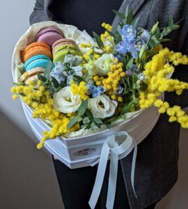 Flowers in a heart box with mimosa and macaroons