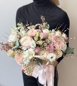 Flower basket with ranunculus and roses